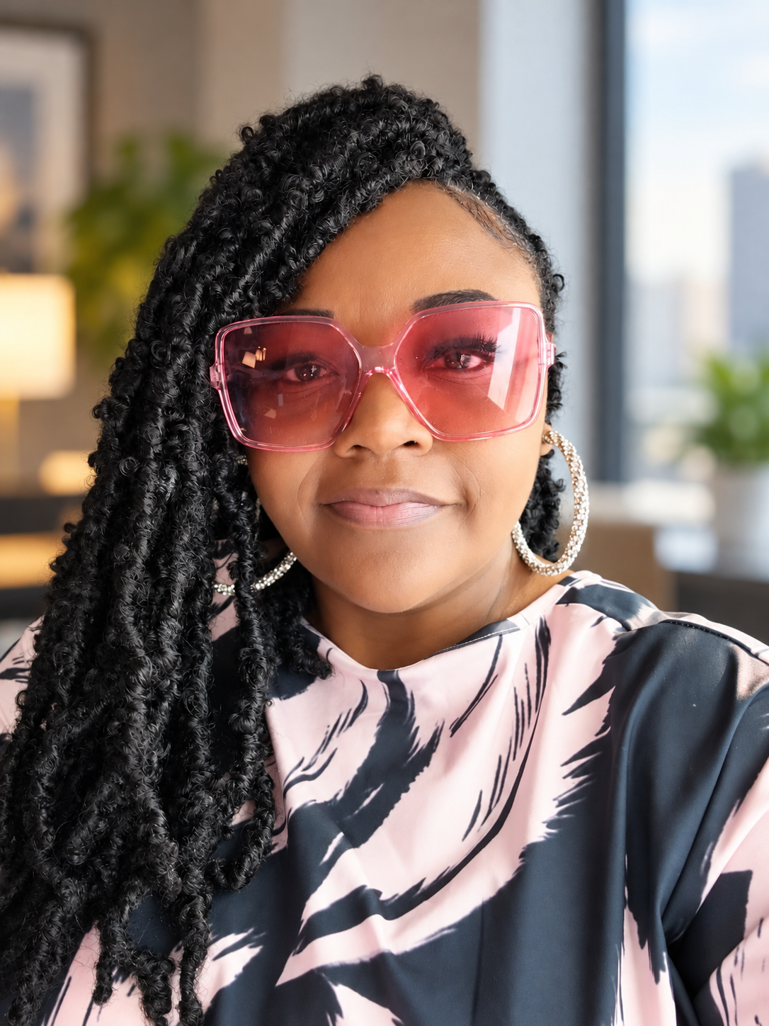 LaVonya Reeves wearing pink sunglasses and silver hoop earrings